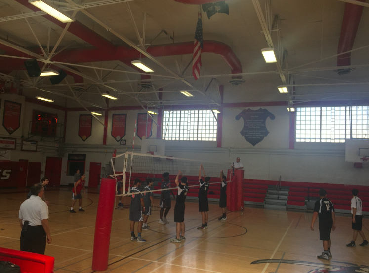 Both teams prepare for the serve.