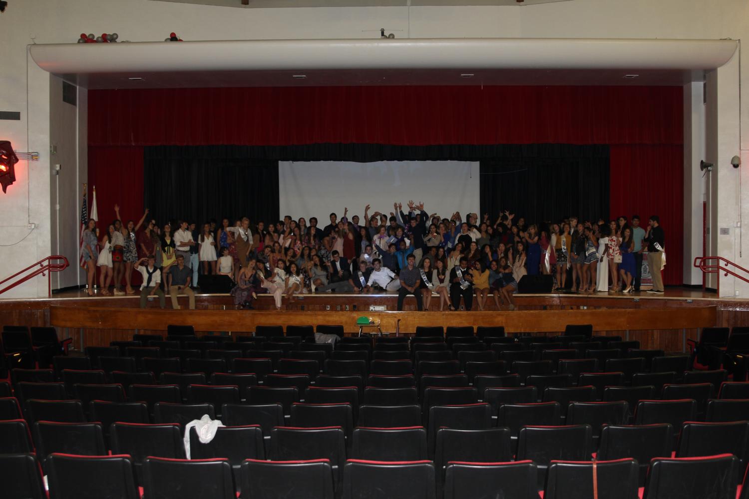IB seniors on stage with Mrs. Hoffman and Mrs. Verazain for one last goodbye photo.