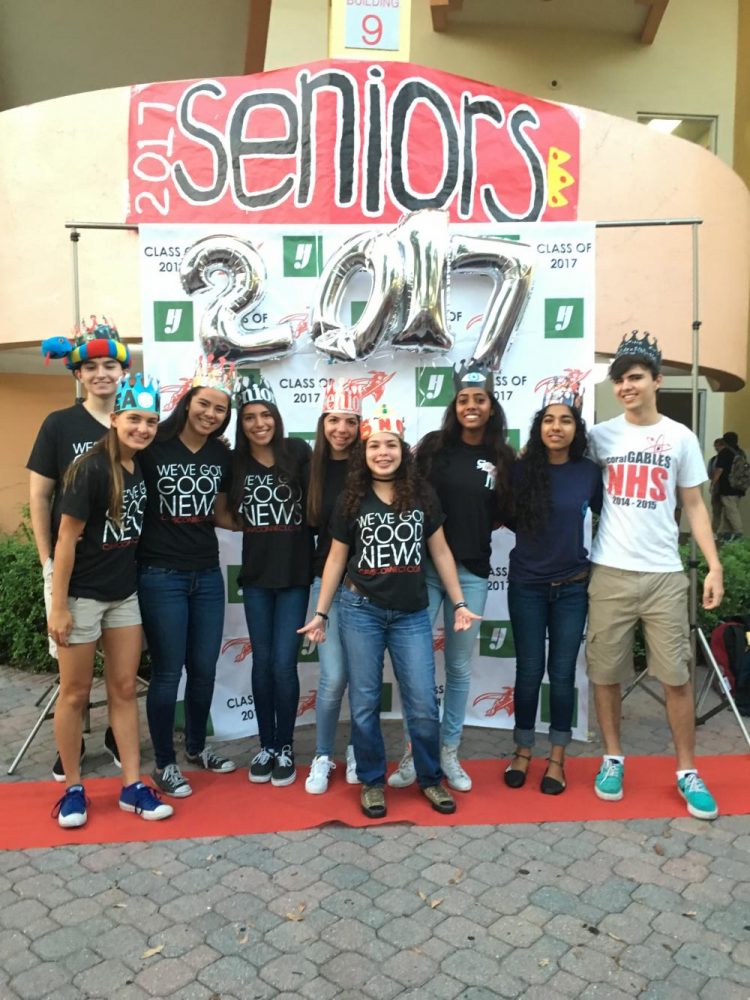 Wearing their crowns, seniors pose in front of the Ralph Moore Building. 