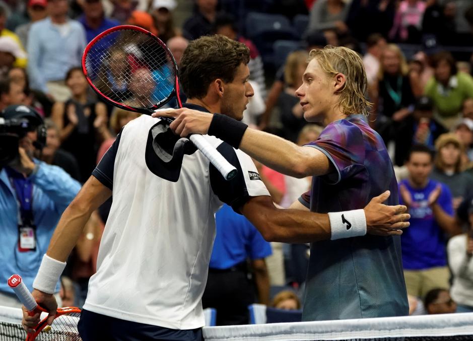 Pablo Carreño Busta (left) and Denis Shapovalov embrace after Carreño Busta ends Shapovalovs unprecedented run.