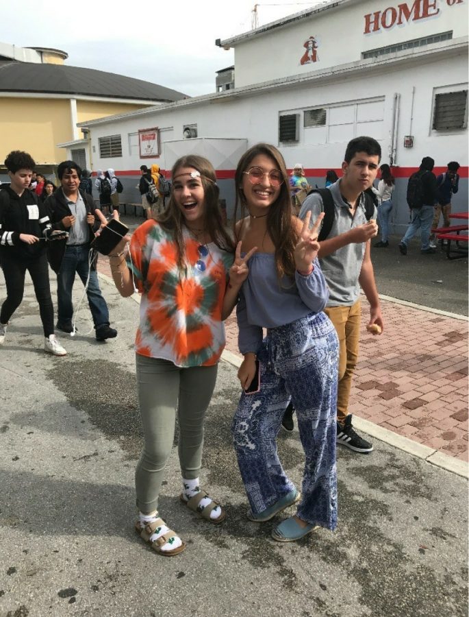 Two students wearing old-style clothing (one guy in the background photo-bombing)