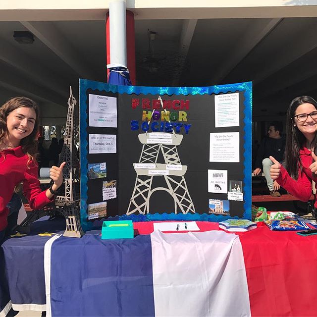 Officers of FHS stand next to the display during the club fair. 