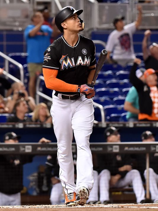 Giancarlo Stanton glances at his home run prior to trotting around the bases.