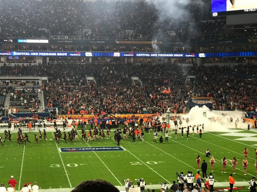 The Canes swarm the field for the start of the Capital One Orange Bowl at Hard Rock Stadium