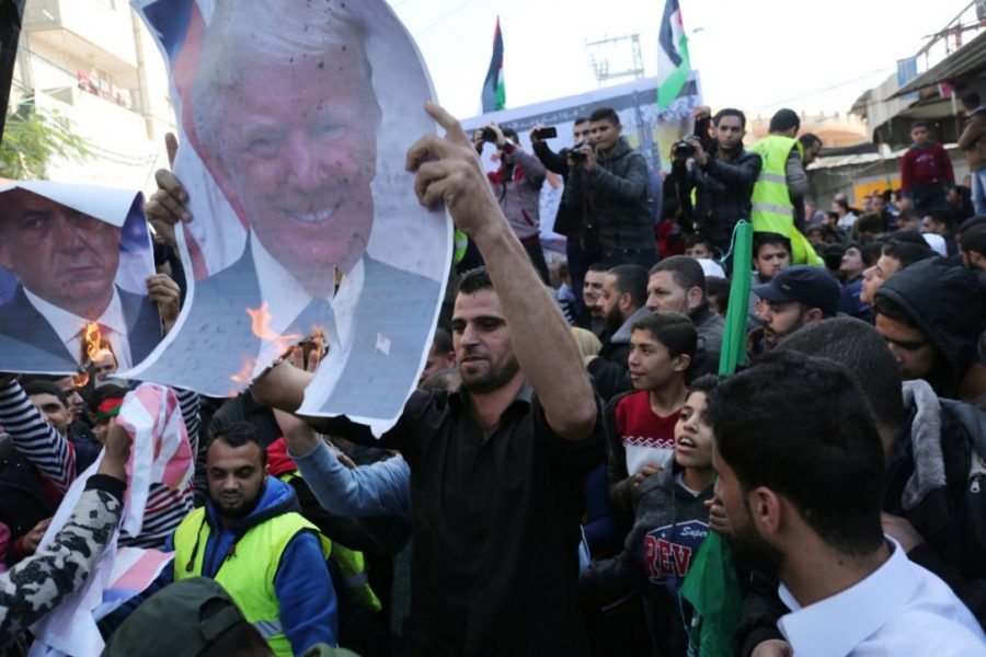 Protesters in Palestine burn photos of President Trump for his decision to move the US embassy in Israel to Jerusalem.