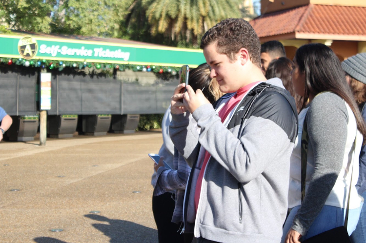 Junior Alain Perez takes a photo of his friends.