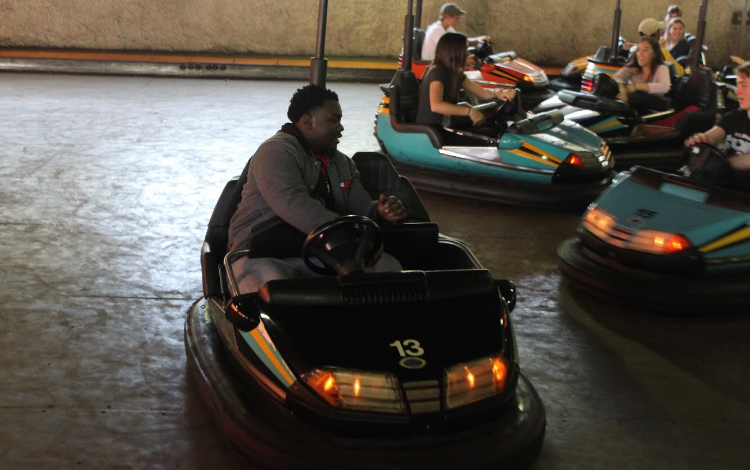 Students take a break from the thill of roller coasters and enjoy go-carting.