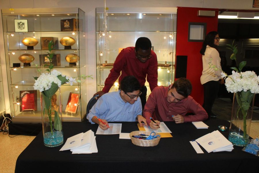 Volunteers sign students in.