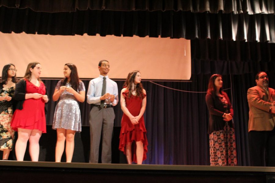 IB Junior students walk across the stage to get pinned.