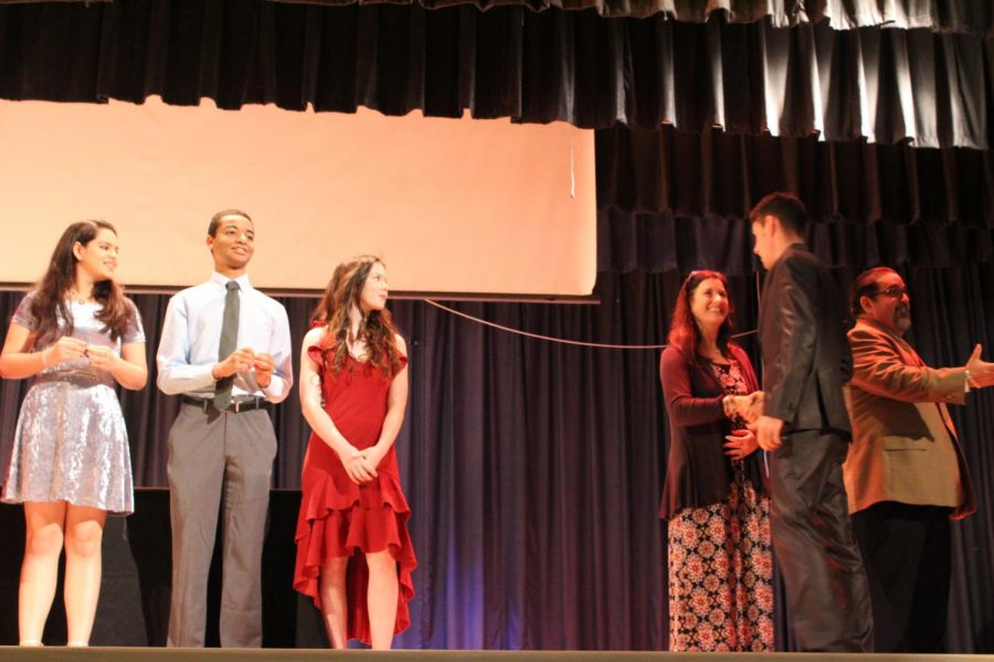 IB Junior students walk across the stage to get pinned.