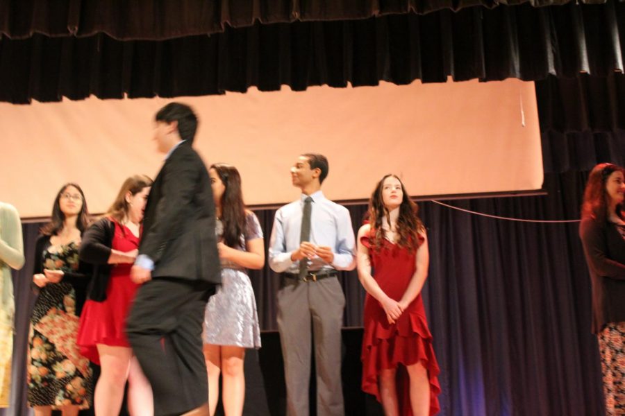 IB Junior students walk across the stage to get pinned.