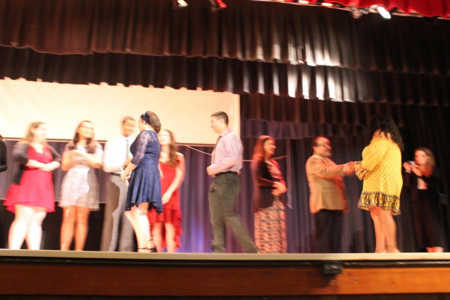 IB Junior students walk across the stage to get pinned.