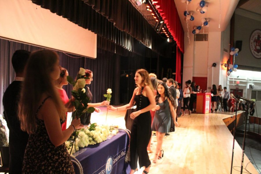 IB Junior students walk across the stage to get pinned.