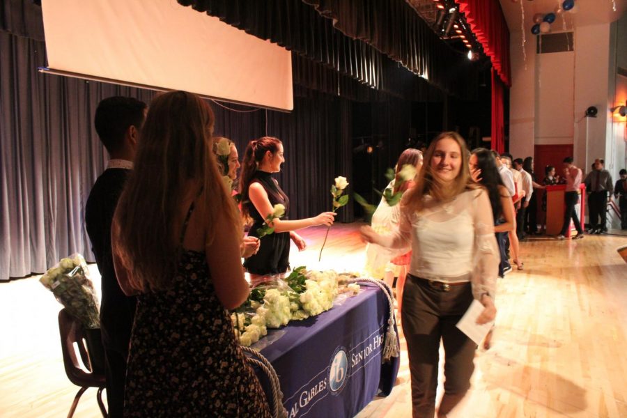 IB Junior students walk across the stage to get pinned.