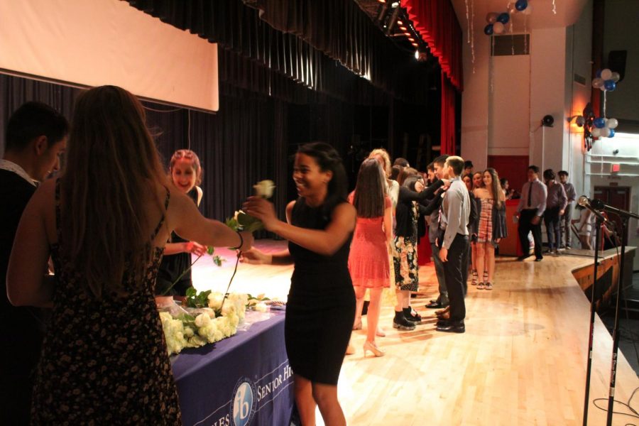 IB Junior students walk across the stage to get pinned.