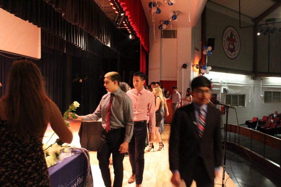 IB Junior students walk across the stage to get pinned.