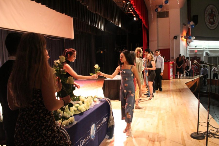 IB Junior students walk across the stage to get pinned.