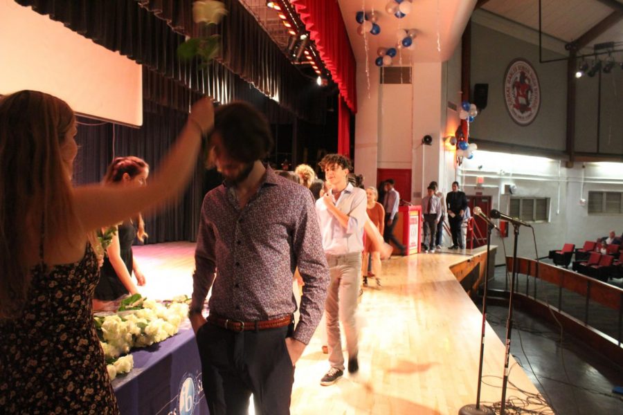 IB Junior students walk across the stage to get pinned.