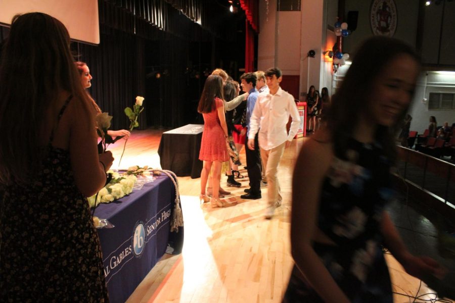 IB Junior students walk across the stage to get pinned.