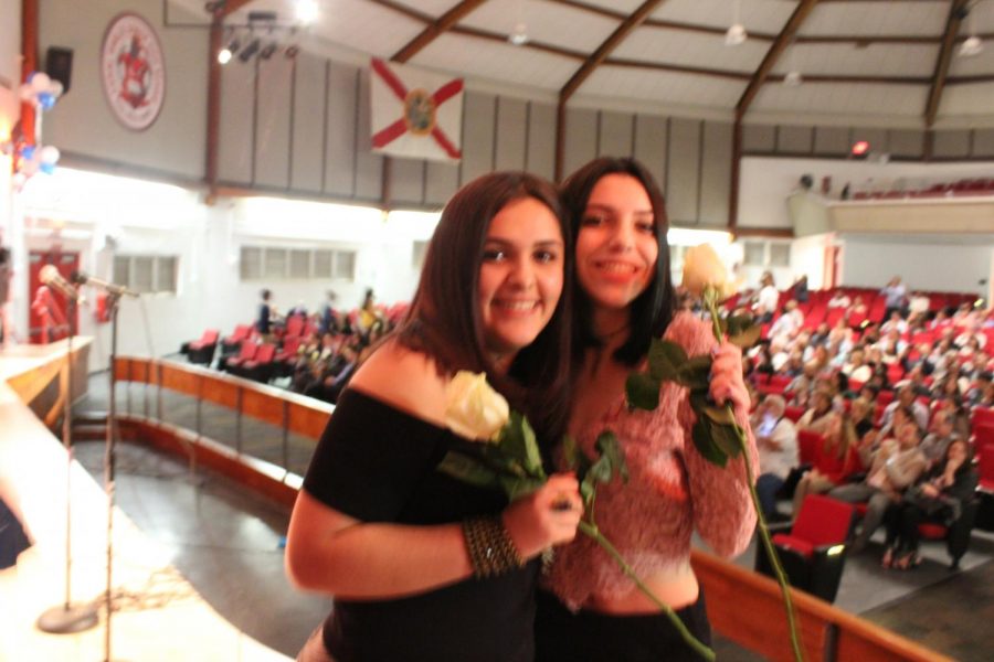 IB Juniors Eve Adan and Brianna Fernandez smile for a picture.