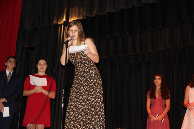 IB senior Sarah Saliamonas congratulates the class in a foreign language.