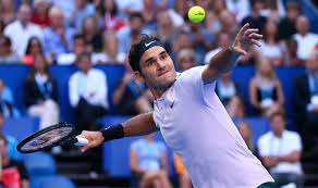 Roger Federer, winner of the Men's Singles at the Australian Open, prepares to hit a tennis ball.