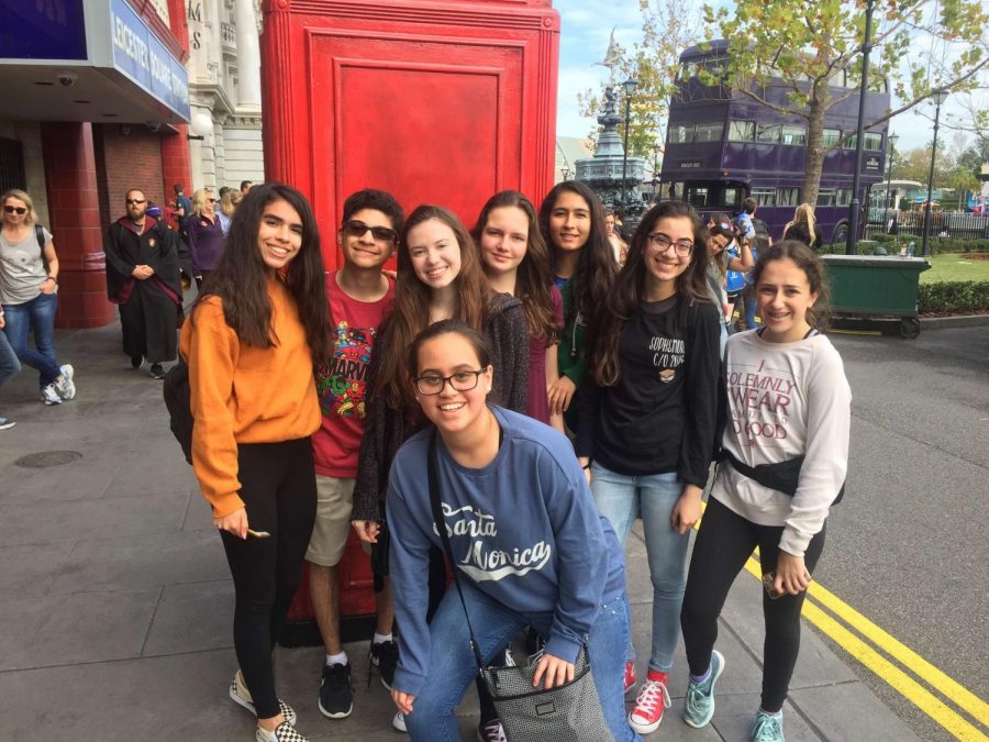Sophomores stand in front of Universals London telephone booth replica and smile for a picture.