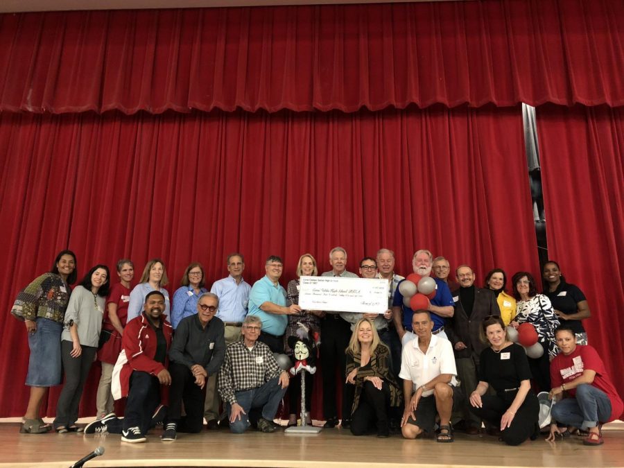 Members of the class of 1967 smile for a picture with administrators and PTSA board members.