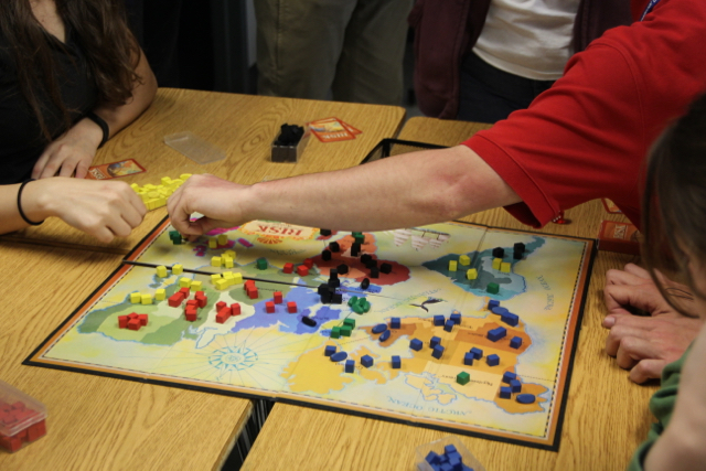 Students play board games as an interactive way to learn history.