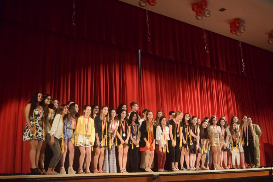 Class of 2019 Summa cum laude students pose for a photo after being awarded their medal and tassel for graduation.