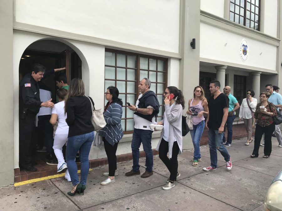 Colombian citizens stand in line outside the consulate, waiting to register as voters for the Colombian presidential elections.