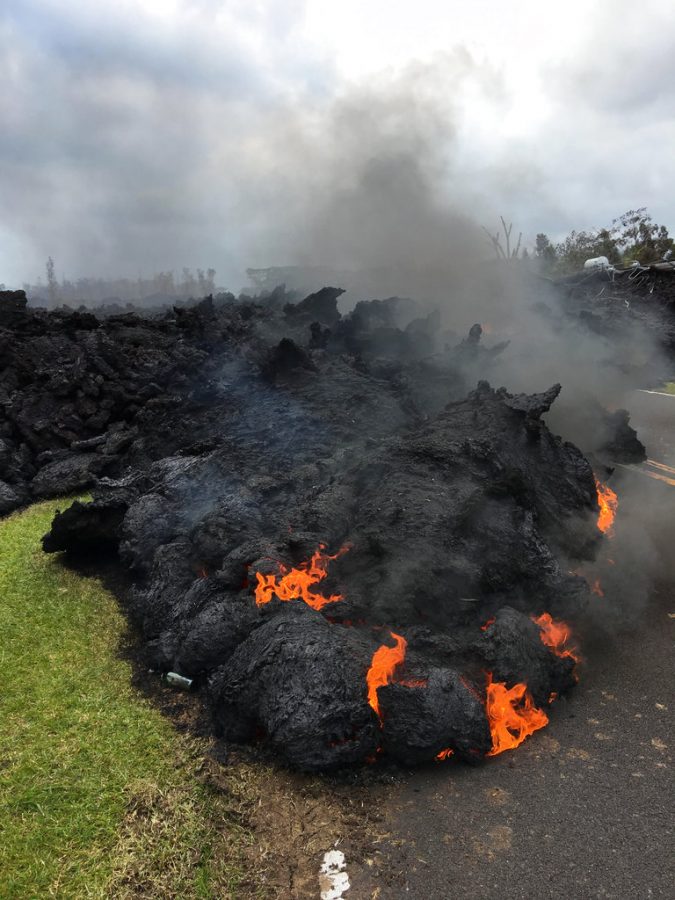 Lava oozing out from the fissures in the middle of the road.