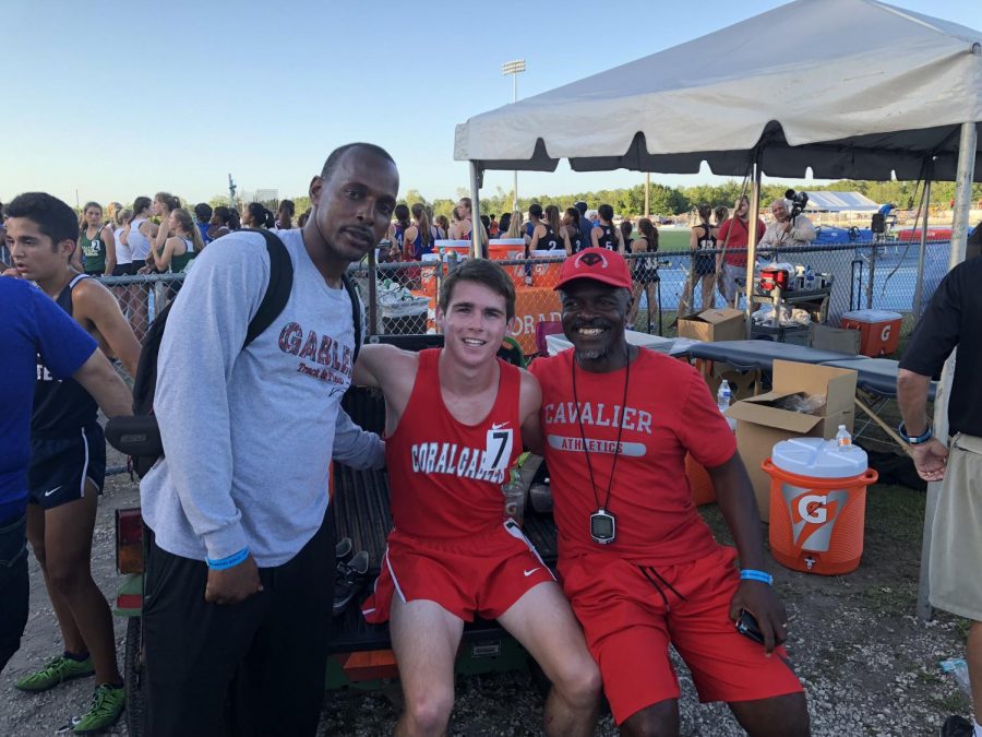 Cavan Wilson celebrates his victory alongside his two coaches.