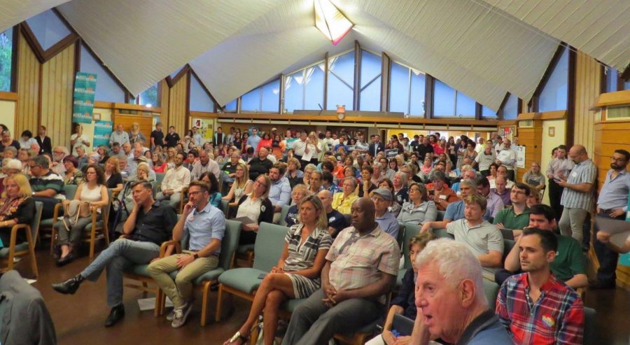 The crowd settles down as the debate begins. 