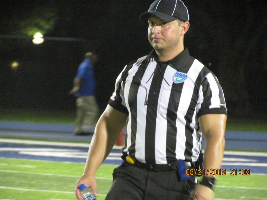 One of the referees officiating the game. 