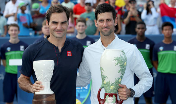 Roger Federer (left) and Novak Djokovic (right) receive their trophies after Djokovic won the Cincinnati Masters tournament on Aug. 19. 