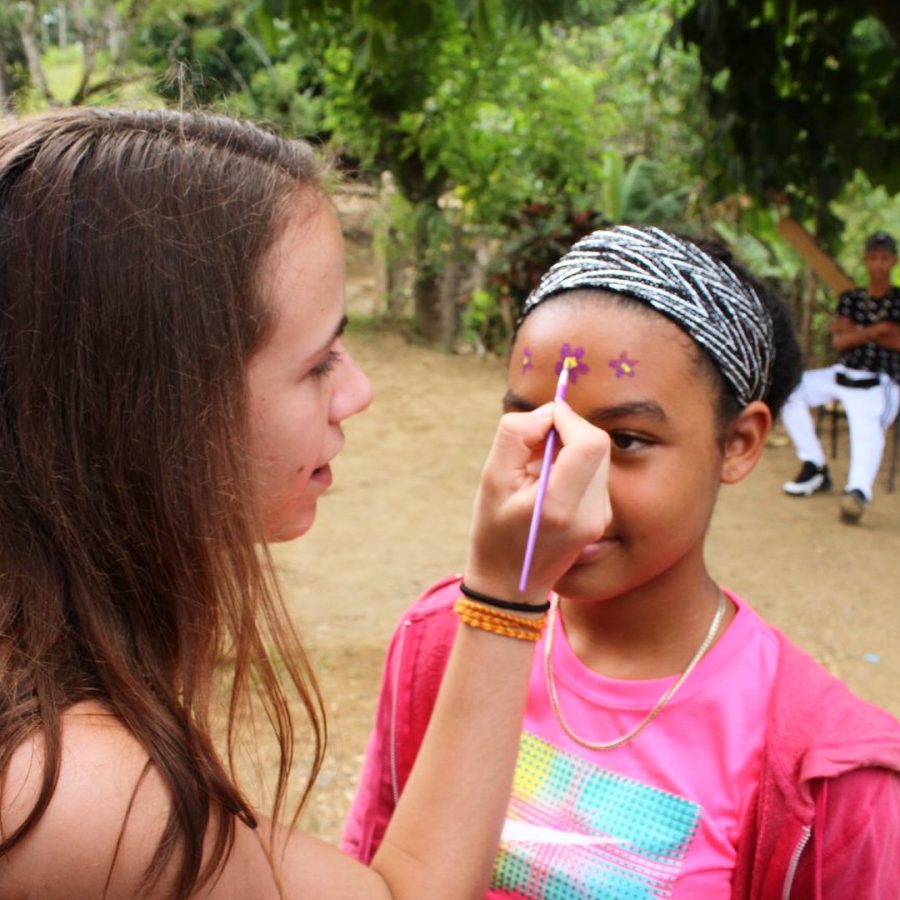 Senior Marina Torras spending time with community during Dominican Republic mission trip. 
