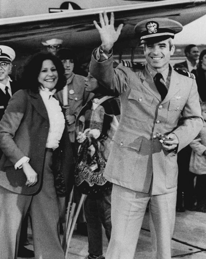 John McCain, then a Lieutenant in the Navy, waves on to a group of people welcoming him back in 1973 from his 5-year internment in a Vietnamese camp. 