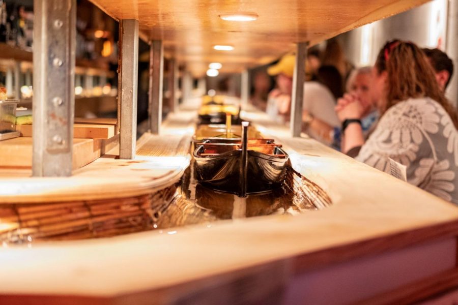 Boats circle around the restaurant with sushi waiting to be picked.