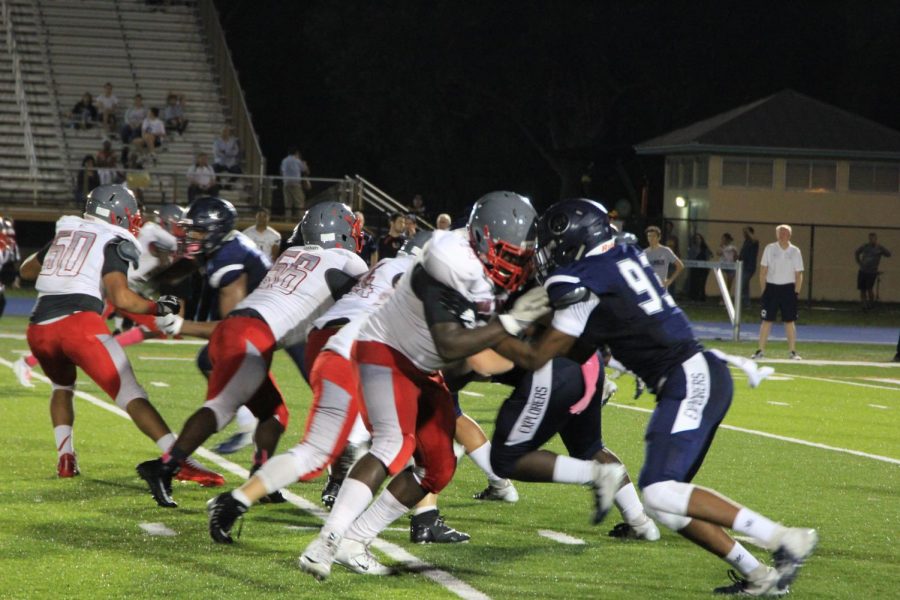 The Coral Gables and Columbus football teams take the field and compete in a heated match-up.