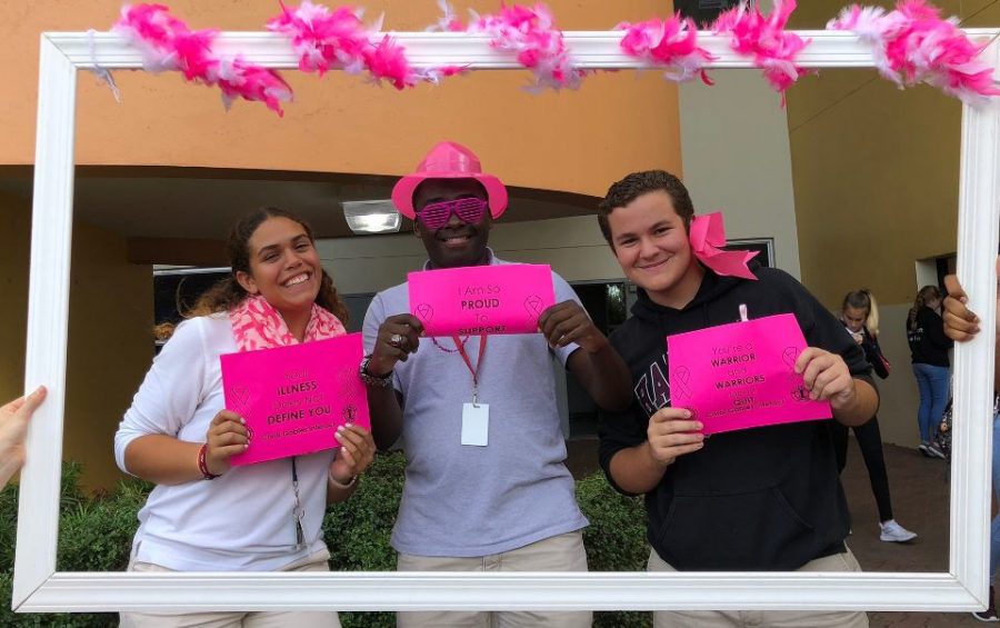 Students take pictures while taking part in Interact Pink Week