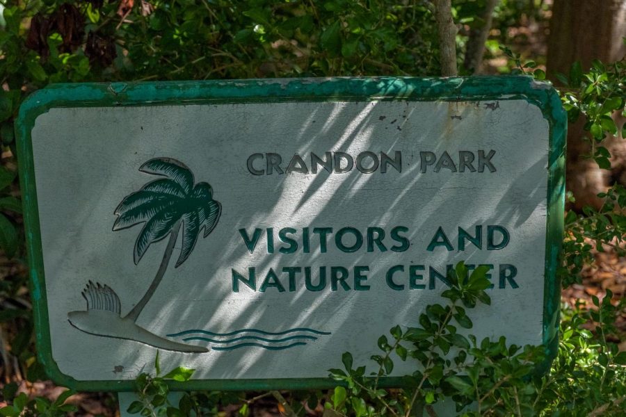  A small sign, partially hidden in the bushes, greets Nature Center visitors. 