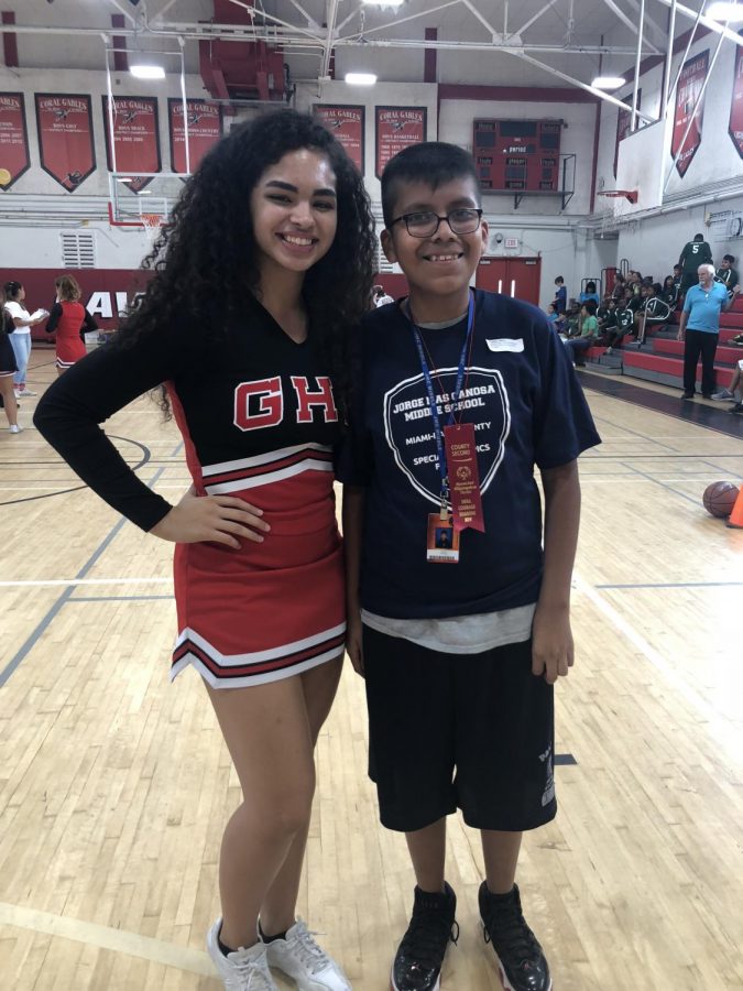 Cheerleader Melissa Rodriguez stands with eighth grader Jesus Franco from Jorge Mas Canosa Middle School at the Basketball Competition.