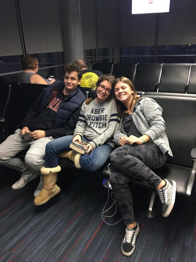 Mathilde alongside her family and best friend at the airport.