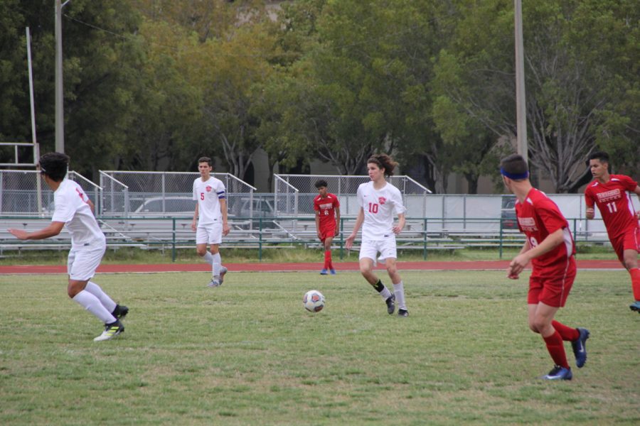 The Boys Soccer team charges up the field on offense.