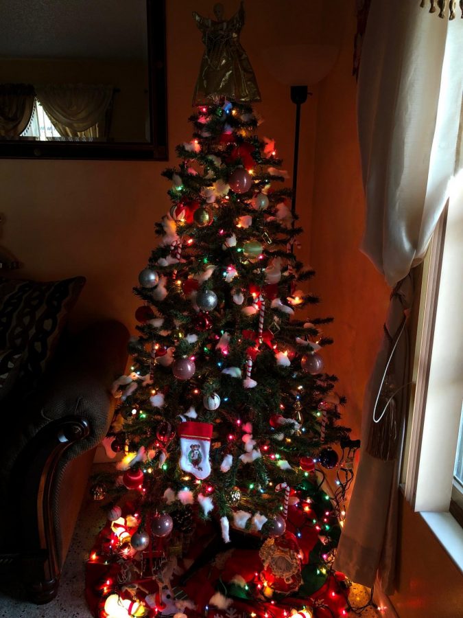 A Christmas tree with a variety of different color ornaments.