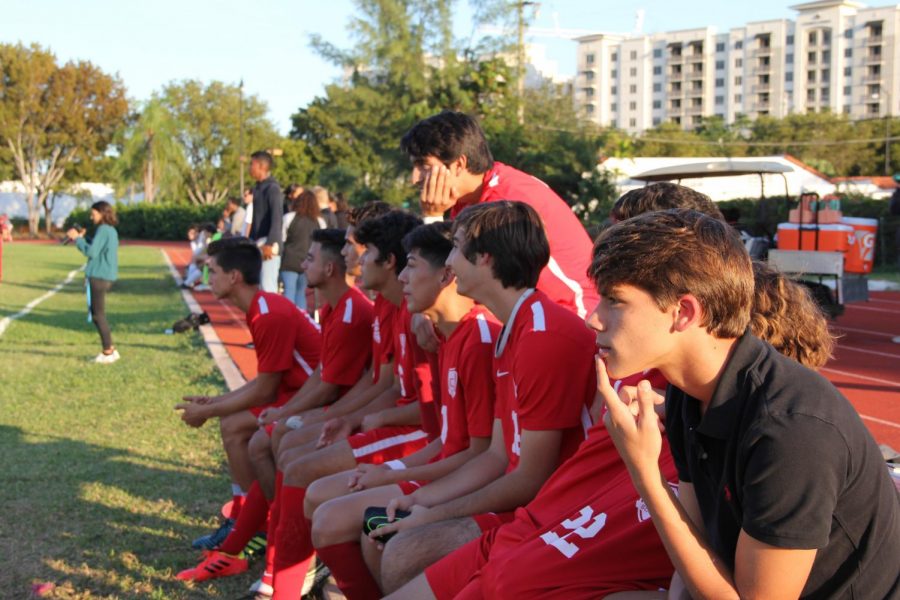 Cavalier Soccer players watching their teammates play from the sidelines.