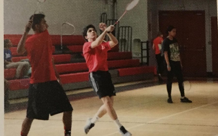Junior AJ Vazquez strikes the shuttlecock with his racket in a practice session.