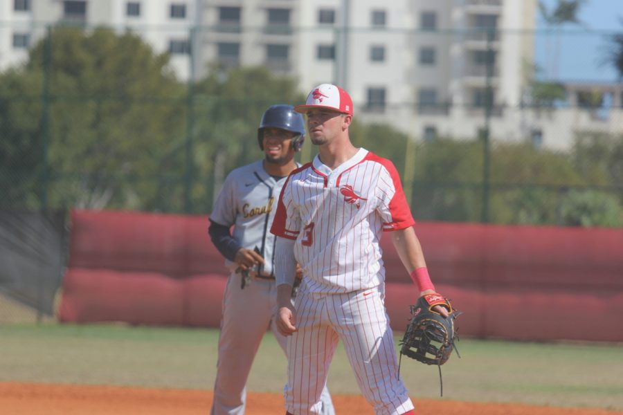 Senior Ernest Denis eyes the plate while patrolling first base.