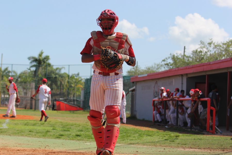 Senior catcher Gerardo Rodriguez approaches the home plate and readies to handle his pitcher.